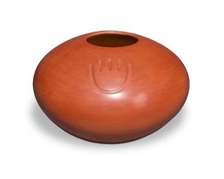 275
Tina Garcia (1957-2005, Santa Clara Pueblo/San Juan Pueblo Ohkay Owingeh)
A large redware jar, late 20th century
Incised to underside: Tina Garcia / San Juan / Santa Clara / [cipher]
The ovoid form jar with three bearpaw motifs
6.5" H x 10" Dia.
Estimate: $600 - $900
