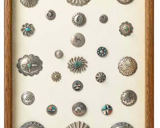 80
A framed collection of Navajo silver buttons
Late 19th century and later, Diné
A large group of silver buttons of various sizes and styles including stamped designs, repoussé, cast designs, and silver overlay, many with set turquoise or stone inlay, and some with motifs including jackrabbits, birds, whirling logs, and Sunface, each securely mounted to a cardboard backing
25 pieces
Sight: Largest: 2" Dia.; Smallest: 0.625" Dia.
Estimate: $800 - $1,200