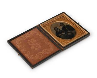 217
A Civil War era tintype
A tintype depicting a family portrait, with a chased gold-toned metal preserver within a burnt orange velvet-lined tooled leather case
Sight: 2.5" H x 2" W
Estimate: $300 - $500