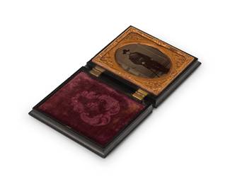 219
A Civil War era tintype
A tintype depicting a cavalry soldier posing with his sword, with a chased gold-toned metal preserver within a magenta velvet-lined black thermoplastic case
Sight: 2.5" H x 2" W
Estimate: $250 - $350