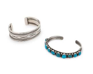 321
Two Southwest sterling silver cuff bracelets
Mid/late 20th century
Each unmarked
Comprising a heavy three-wire silver cuff bracelet with stamped banding and edge accents, as well as a narrow three-wire silver cuff with a single row of graduated set turquoise cabochons with silver ball spacers
2 pieces
Larger: 7.25" total inner C x 0.875" H, with a 1.25" gap; Smaller: 7.25" total inner C x 0.375" H, with a 1" gap
78.7 grams gross
Estimate: $300 - $500