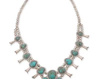 308
A Richard S. Begay Navajo sterling silver and turquoise squash blossom necklace
Richard S. Begay (b. 1943, Diné)
Late 20th/21st century
Stamped: RB / Sterling
With a large seven-stone naja and ten graduated set turquoise blossoms on a double silver bead strand
27.5" L x 2.625" H
125.8 grams gross
Estimate: $800 - $1,200