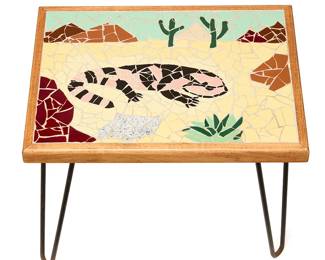 154
A Southwest-style mosaic side table
Early 21st century
The tile mosaic depicting a gila monster in a desert landscape with saguaro cacti, set in a wood frame and raised on four enameled metal legs
17" H x 21.5" W x 15.75" D
Estimate: $200 - $300