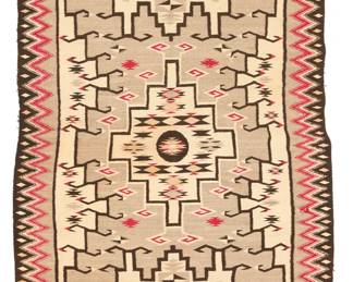 69
A Navajo regional rug
Mid-20th century, Diné
Woven in red, dark brown, cream, tan, and variegated grey wool with three central elaborate stepped hooked motifs, with various floating diamond motifs overall and an elaborate zigzag border with striped banding to the ends
88.5" H x 48" W approximately
Estimate: $300 - $500