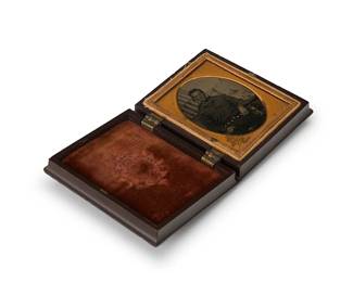 236
A 19th century tintype of a sailor
A tintype featuring a portrait of a sailor in front of a faux boat background, with a chased gold-toned metal preserver within a burnt orange velvet-lined brown thermoplastic case
Sight: 2" H x 1.625" W
Estimate: $200 - $300