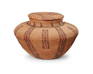 161
A polychrome Yokuts lidded basket
Late 19th/early 20th century; Central California
A finely coiled tapered bottle neck lidded basket with alternating vertical conjoined diamond "rattlesnake" banding
5" H x 7.5" Dia.
Estimate: $800 - $1,200