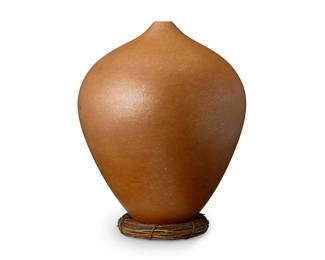 39
Hubert Candelario (b. 1965, San Felipe Pueblo)
A large micaceous redware pottery vessel, late 20th century
Signed indistinctly to underside
A tall tapered ovoid narrow neck vase-form jar with sparkling micaceous finish
14" H x 10.5" Dia. approximately
Estimate: $800 - $1,200