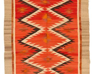 64
A Navajo regional rug
Early 20th century, Diné
Woven in reds, oranges, brown, cream, and grey wool with central stacked Saltillo-style sawtooth diamonds and a banded border.
61" H x 45" W approximately
Estimate: $600 - $800