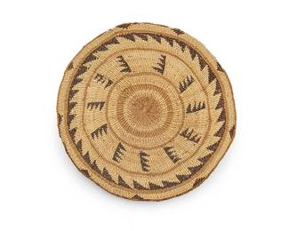 170
A large polychrome Klamath/Modoc basketry tray
Mid/late 20th century; Northern California/Southern Oregon
The wide twined conical tray with imbricated motifs including sawtooth banding and multiple serrated columns of stacked triangles
3.5" H x 16.5" Dia. approximately
Estimate: $300 - $500