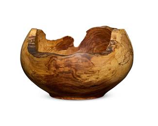 296
A large Andrew Pearce turned wood bowl
Early 21st century
With artist's burned shop mark to underside
The burlwood footed bowl with live edge rim
10.25" H x 17.25" W x 16.25" D
Estimate: $250 - $350