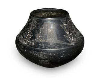 3
Maria Martinez (1887-1980, San Ildefonso Pueblo)
A blackware pottery jar, circa 1920-1925
Incised to underside: Marie
The jar with black on black stepped and stacked triangle motifs to shoulder
5.5" H x 7" Dia.
Estimate: $500 - $700