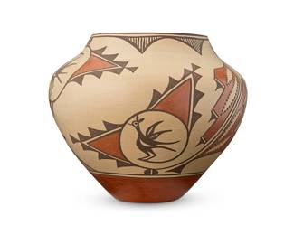 274
Sofia Medina (1932-2010, Zia Pueblo)
A large Zia Pueblo polychrome olla, late 20th century
Signed in slip to lower side: Sofia Medina / Zia
The large rounded jar with scattered bird medallion motifs within stepped triangles and stylized feather motifs, fine line rim edging, and a red base
9.625" H x 11.5" Dia.
Estimate: $200 - $400