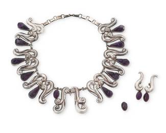 316
A set of Mexican sterling silver and amethyst jewelry
Mid-20th century
Stamped: FD / Mexico / Sterling / 1026 [design number]
Comprising a sterling silver collar necklace with scrolled links set with carved amethyst mask motif teardrop and oval accents, with a pair of matching earrings
3 pieces
Necklace: 17" L x 1.75" H; Earrings: 1.75" H
131.8 grams gross
Estimate: $400 - $600