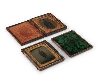 231
Two Civil War era early photographs
Two tintypes depicting a Union soldier, one with a chased gold-toned metal preserver within a green velvet-lined tooled leather case, the other in a similar case lined with orange velvet
Sight of each: 2.5" H x 2" W
Estimate: $400 - $600