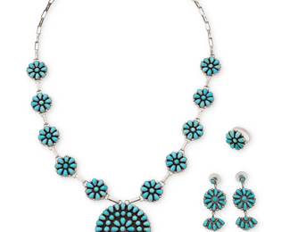 317
A group of Southwest Zuni-style sterling silver and turquoise jewelry
Late 20th century
Three works:

A set of Henry Morris Navajo cluster-set turquoise jewelry
Henry Morris (b. 20th century, Diné)
Each stamped: HTM [conjoined] / Sterling
Comprising a cluster-set turquoise squash blossom-style link necklace with a central medallion and ten "blossoms" joined by paperclip silver links, with a matching cluster-set ring, 2 pieces
Necklace: 29" L x 2" Dia.; Ring: size 8

A pair of Zuni-style cluster-set turquoise earrings
Each stamped: VJP / Sterling
Each with a central medallion suspending a half plaque dangle, 2 pieces
Each: 2" H

4 pieces total
107.2 grams gross
Estimate: $500 - $700