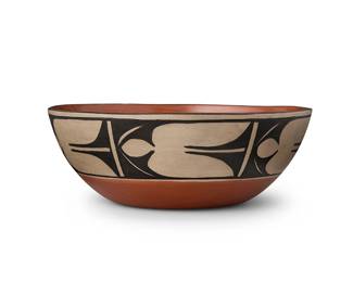 307
Paulita Pacheco (1943-2008, Kewa/Santo Domingo Pueblo)
A Santo Domingo polychrome pottery bowl, late 20th century
Incised signature to underside: Paulita Pacheco / Santo Domingo Pueblo
A stone-polished dough bowl with flared sides and a polished red interior, with a white and black slip band of stylized leaves
4.125" H x 11.5" Dia.
Estimate: $200 - $400