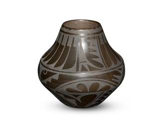 13
Carmelita Dunlap (1925-2000, San Ildefonso Pueblo)
A blackware pottery jar, 1984
Signed and dated to underside: Carmelita Dunlap / San Ildefonso Pueblo / 1984
The stone-polished black on black tall olla with a band of feathers to neck and elaborate curvilinear motifs below
8" H x 8.5" Dia. approximately
Estimate: $500 - $700