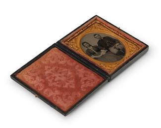 226
A Civil War era tintype
A tintype depicting a seated couple, with a chased gold-toned metal preserver within a red velvet-lined tooled leather case
Sight: 2.5" H x 2" W
Estimate: $300 - $500
