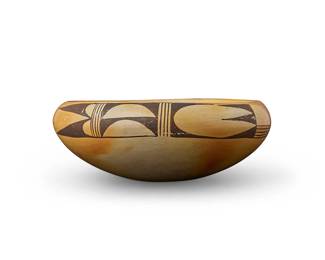 245
A Hopi Pueblo yellowware pottery bowl
Mid-20th century
The bowl with brown swirling geometric motifs to interior and rim exterior
3.25" H x 8.5" Dia.
Estimate: $200 - $400
