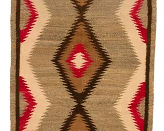 72
A Navajo regional rug
Mid-20th century, Diné
Woven in cream, red, dark brown, tan, and variegated grey wool, with a central column of conjoined serrated diamonds and half diamonds to the sides, with a banded border
51" H x 34" W
Estimate: $300 - $500