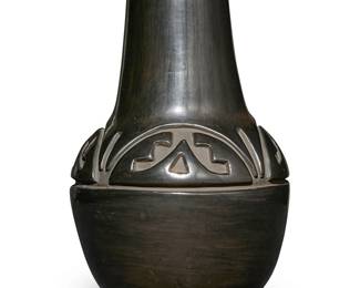 17
Mela Youngblood (1931-1990, Santa Clara Pueblo)
A blackware pottery vase, mid/late 20th century
Incised to underside: Mela Youngblood / Santa Clara Pue.
The vessel with deeply incised banded stepped motifs to base of shoulder
12.125" H x 8.25" Dia.
Estimate: $800 - $1,200