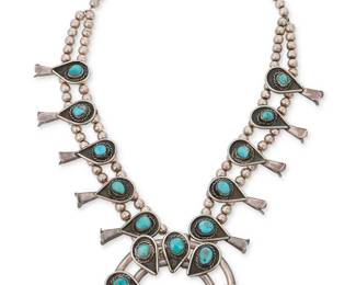 310
A Southwest silver and turquoise squash blossom necklace
Late 20th century
Unmarked
With a sterling silver two-wire stone-set naja and ten tear-drop blossoms on a double strand of silver beads
22" L x 3" H
190.1 grams gross
Estimate: $600 - $900
