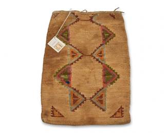 57
A Nez Perce twined corn husk bag
Late 19th/early 20th century, Nimiipuu; Northwest Plateau
The double-sided flat twined bag with polychrome wool yarn imbricated motifs to each side, featuring a scattered array of small rectangles to one side and multiple interlocking stepped diamonds verso, with fabric binding, rawhide lacing and two rawhide loops attached to one side
16.25" H x 11.5" W
Estimate: $1,000 - $1,500