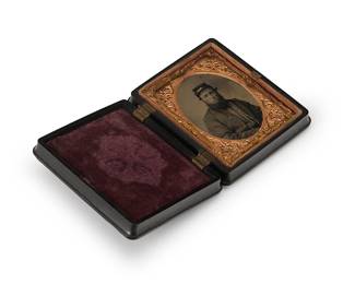 218
A Civil War era tintype
A tintype featuring a portrait of a bearded man, with a chased gold-toned metal preserver within a magenta velvet-lined black thermoplastic case
3" H x 2.5" W
Estimate: $200 - $300