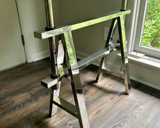 Side view of the 1” glass top & sawhorse -style chrome desk