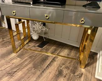 Gray laminate cabinet with brass accents