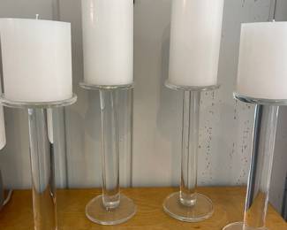 There are several chunky glass candlesticks