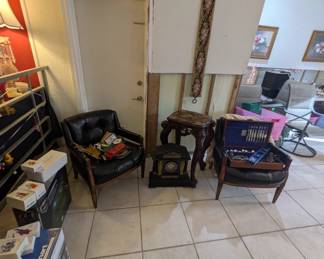 Leather club chairs, antique stone mantle clock, Chinese table with inlaid mother of pearl decoration