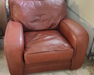Overstuffed leather chair and ottoman.