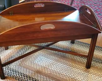 Pretty wood table with pull up sides. 