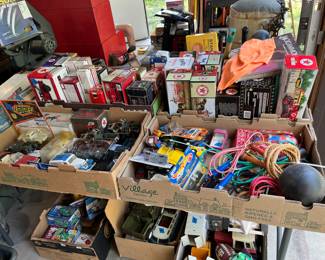 Boxes of Ertl trucks and other toys