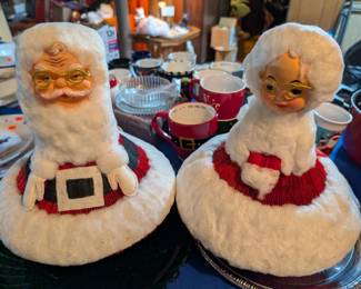 Mr. & Mrs. Claus. Their bodies are made of folded paper.