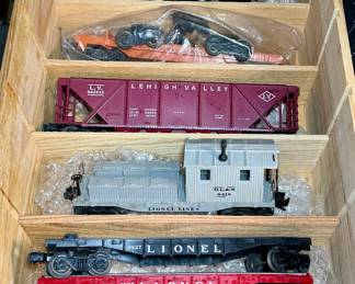 postwar lionel locomotives flat cars box, cars, and caboose, and Tie jecter car 