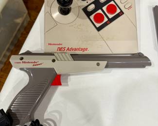 NES Advantage joystick, Nintendo Zapper gun, vintage NES accessories, retro Nintendo collectibles, 1980s gaming controllers.