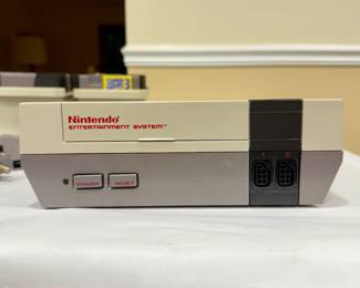 NES Advantage joystick, Nintendo Zapper gun, vintage NES accessories, retro Nintendo collectibles, 1980s gaming controllers.