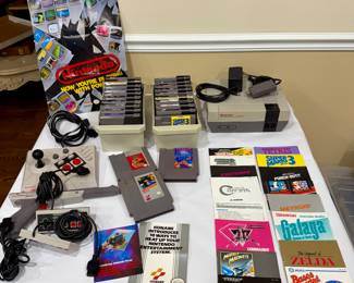 NES lot, vintage Nintendo collection, NES console with games, NES manuals and poster, retro video game bundle, collectible 1980s Nintendo.
