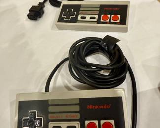 NES controllers, original Nintendo gamepads, vintage NES accessories, retro video game controllers, 1980s Nintendo collectibles.
