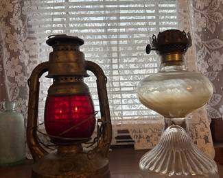Antique metal and red glass oil lantern and glass oil lamp