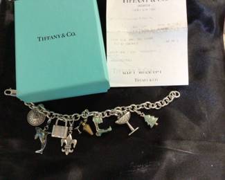 TIFFANY STERLING SILVER CHARM BRACELET WITH 8 playful charms including enamel charms $975