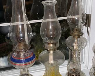 Collection Of Antique Oil Lamps In Varying Sizes