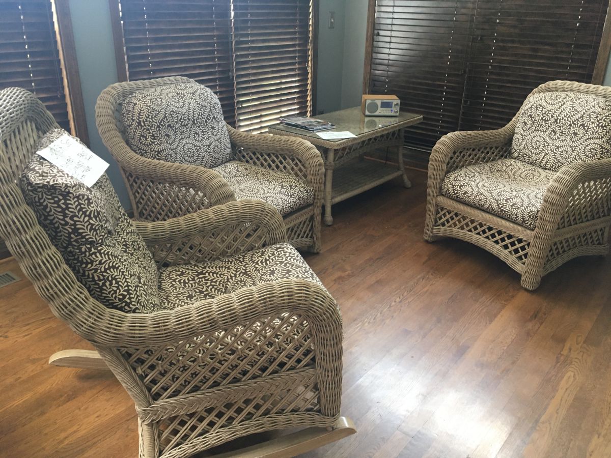 Fine set of wicker furniture, two chairs, rocker and coffee table. Cotton covered cushions.