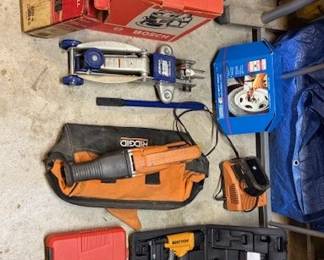 Pictured tools include the Bosch Router (in box), Milwaukee Corded Drill, 1/2" Impact wrench by Campbell Hausfeld, an AC Delco Jack, a Ridgid battery operated 18V reciprocating saw, a Bostitch Staple Gun, and an Amzdeal Vacuum Pump.