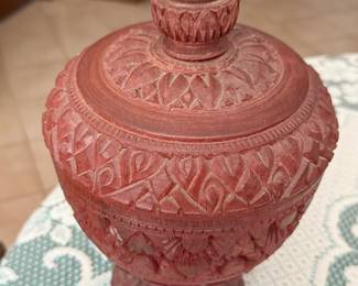 This lidded vessel shows the artistry of Burmese craftsmanship. The color is characteristic of traditional lacquerware from the region.