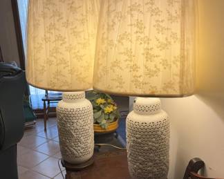 These lovely Blanc de Chine Reticulated Porcelain lamps have been a treasure in our family since the early 70's. They will alternate, simply by pulling a switch, between lighting in the top and lighting in the base of the lamps.