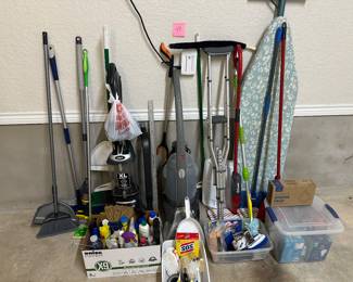 Lot 40.   Large lot of cleaning supplies, shark vacuum, Hoover rug cleaner, brooms, ironing, board, lightbulbs.  $75 