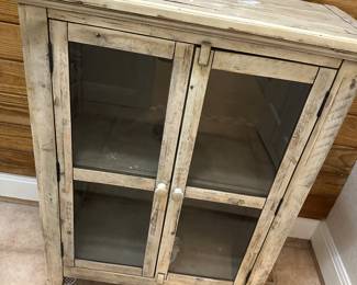 Lot 38 small cabinet, 4 feet tall with glass doors. $48 